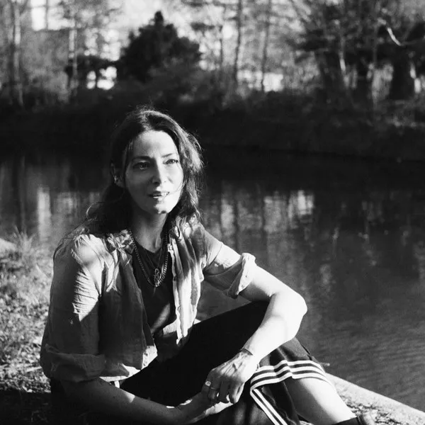 Woman seated by a canal